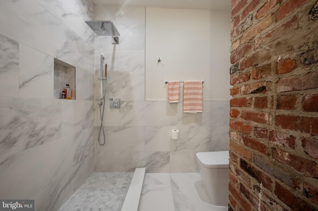 bathroom with tile walls, toilet, and a tile shower