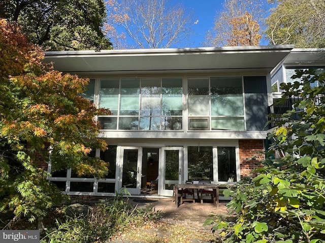 rear view of property featuring french doors and a patio area