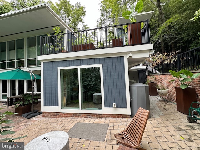 view of patio featuring a balcony