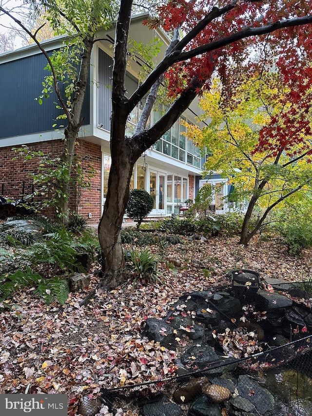 view of side of property with a sunroom