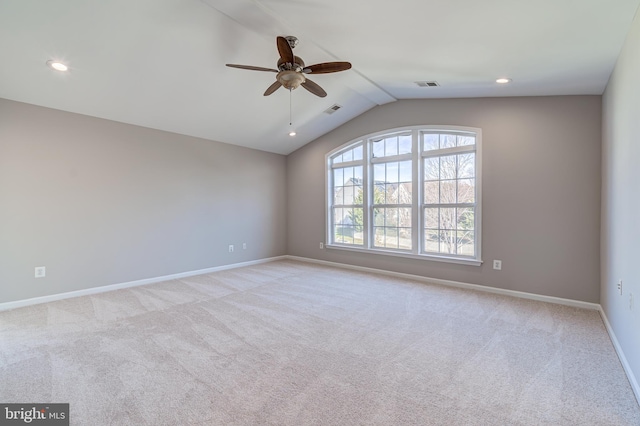 carpeted spare room with lofted ceiling and ceiling fan