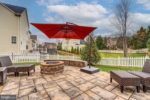 view of patio with a trampoline and a fire pit