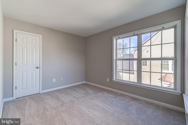 unfurnished room with light colored carpet