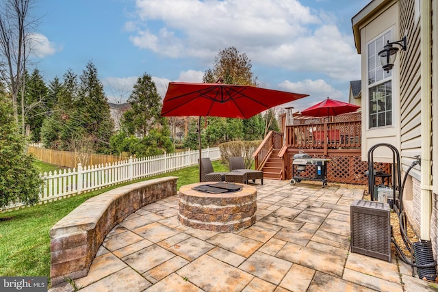 view of patio featuring a wooden deck and a fire pit