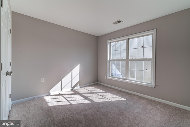 spare room with light colored carpet