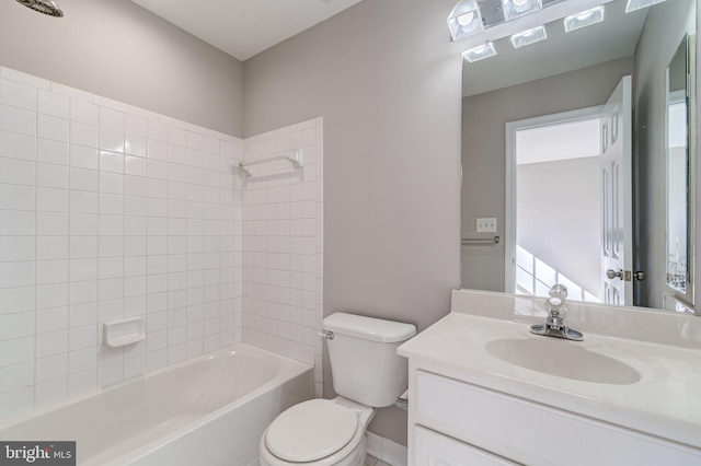 full bathroom with tiled shower / bath, vanity, and toilet