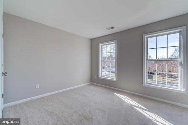 empty room featuring light carpet