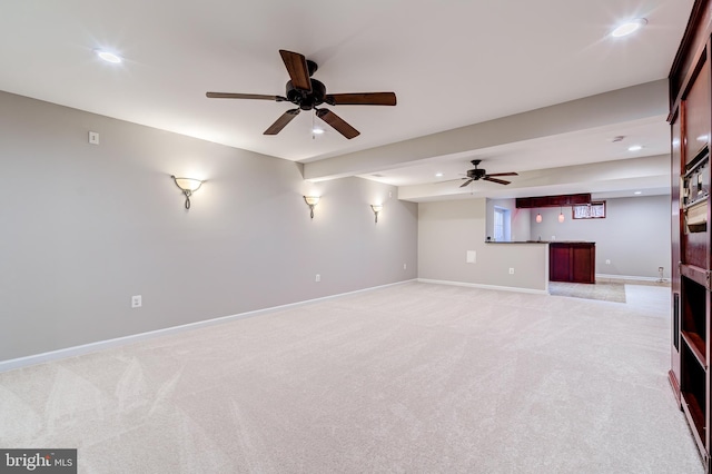 unfurnished living room featuring light colored carpet and ceiling fan