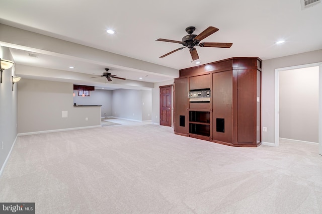 unfurnished living room with ceiling fan and light colored carpet