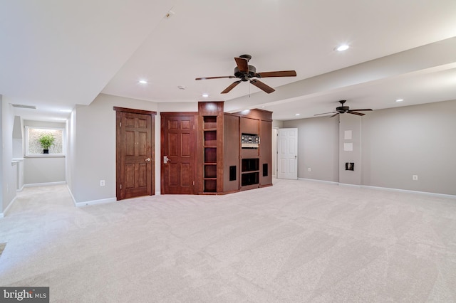 unfurnished living room featuring light carpet and ceiling fan