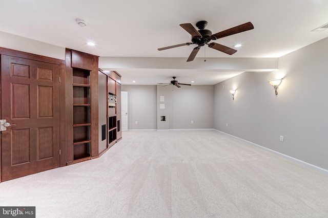 unfurnished living room with light colored carpet and ceiling fan