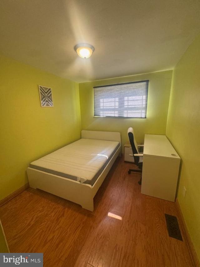 bedroom with hardwood / wood-style floors