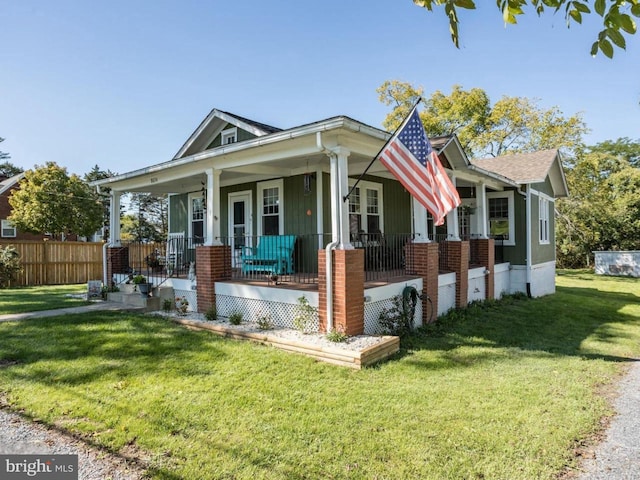 view of front of property featuring covered porch and a front lawn