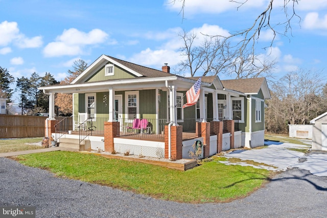 view of front of house featuring a front yard and a porch