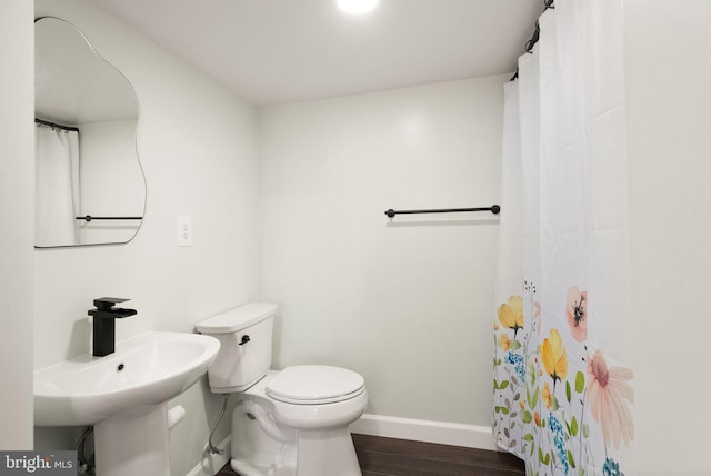 bathroom featuring hardwood / wood-style flooring, sink, and toilet