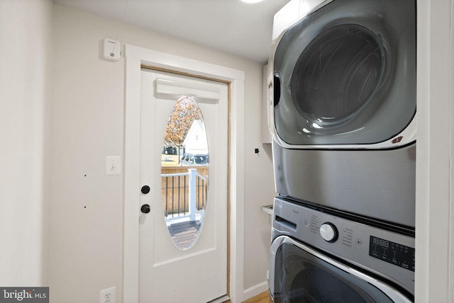 clothes washing area with stacked washer and clothes dryer