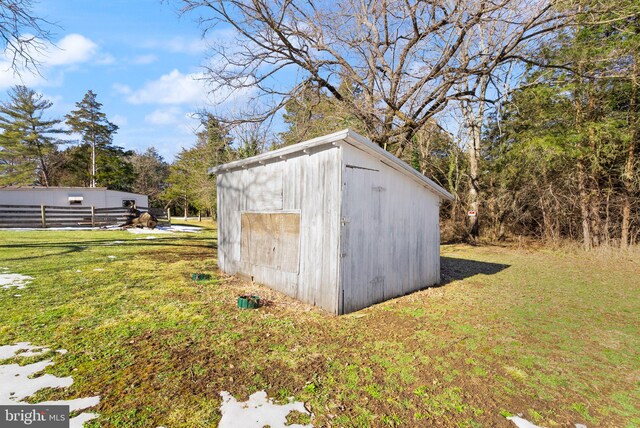 view of outbuilding featuring a yard