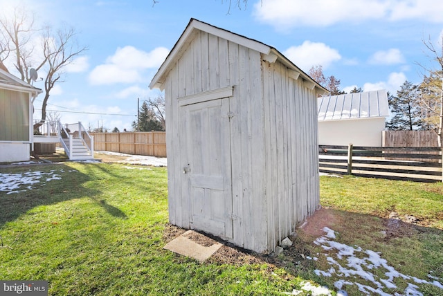 view of outbuilding with a yard