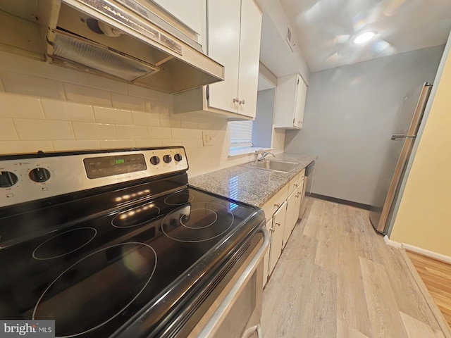 kitchen featuring white cabinetry, light stone counters, stainless steel electric range oven, tasteful backsplash, and light wood-type flooring