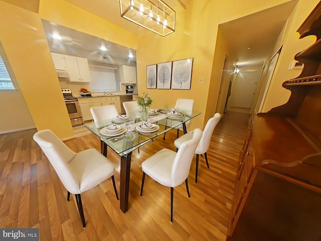 dining space with light hardwood / wood-style floors and sink