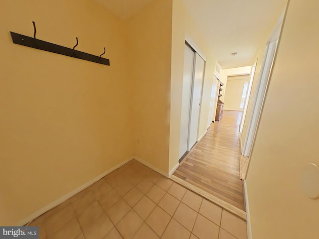 hall featuring light tile patterned floors