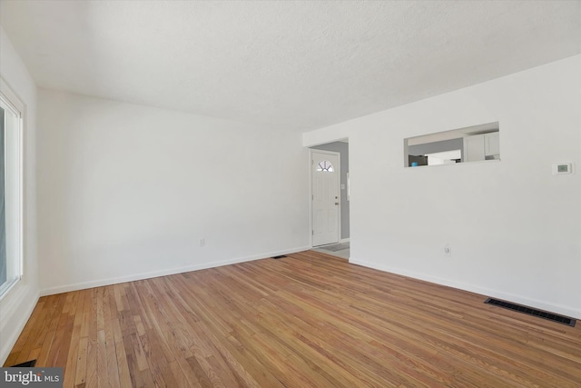 empty room with light hardwood / wood-style flooring