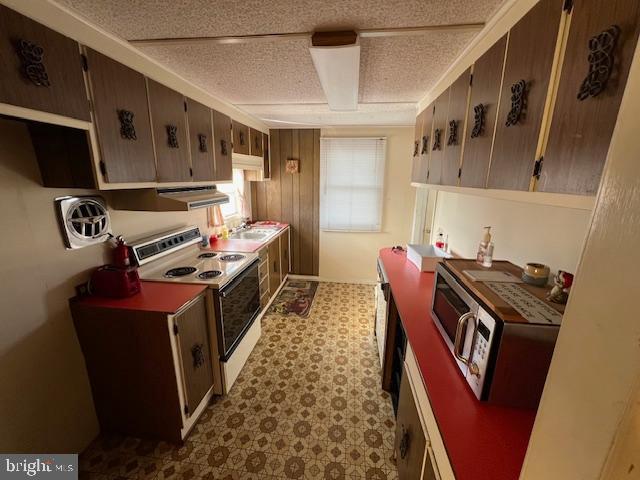 kitchen featuring exhaust hood and white range with electric stovetop