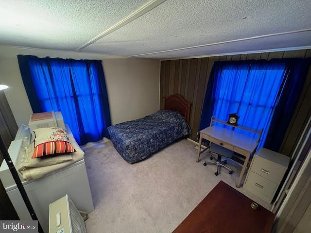 carpeted bedroom featuring a textured ceiling