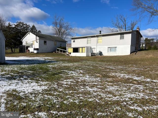 view of snow covered rear of property