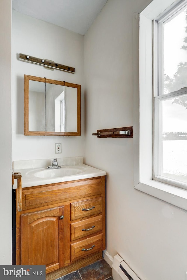 bathroom featuring vanity, plenty of natural light, and a baseboard radiator