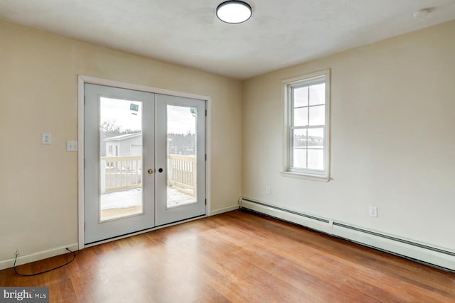 doorway with baseboard heating, french doors, and a wealth of natural light