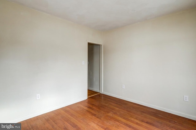 unfurnished room featuring hardwood / wood-style flooring