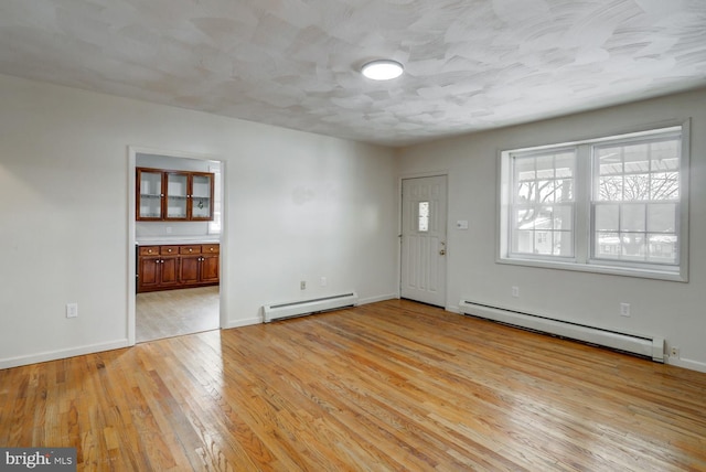 interior space with light hardwood / wood-style flooring and baseboard heating