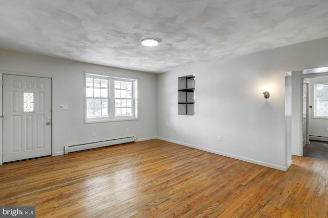 foyer entrance featuring light hardwood / wood-style flooring and a baseboard radiator