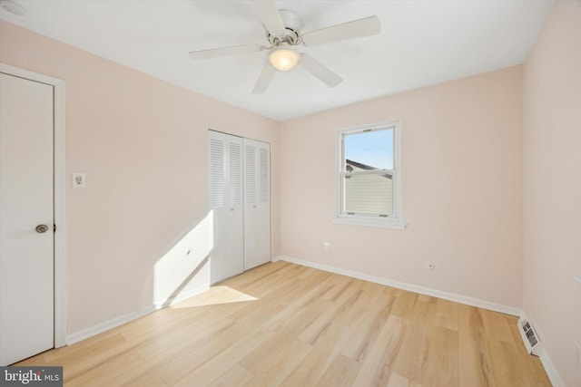 unfurnished bedroom with ceiling fan and light hardwood / wood-style flooring