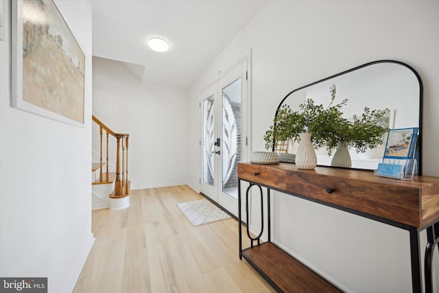 entrance foyer with light hardwood / wood-style flooring and french doors