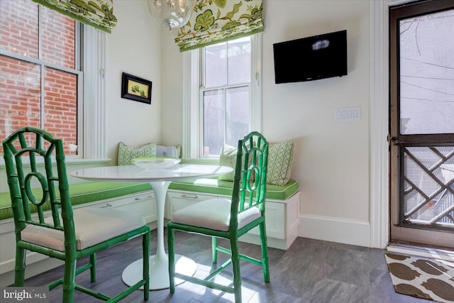 dining room featuring breakfast area and baseboards