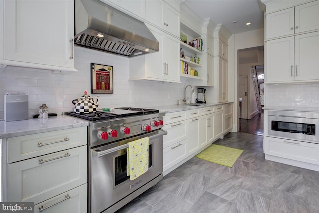 kitchen featuring open shelves, a sink, stainless steel appliances, white cabinets, and wall chimney exhaust hood