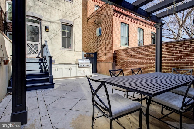 view of patio with area for grilling and outdoor dining area