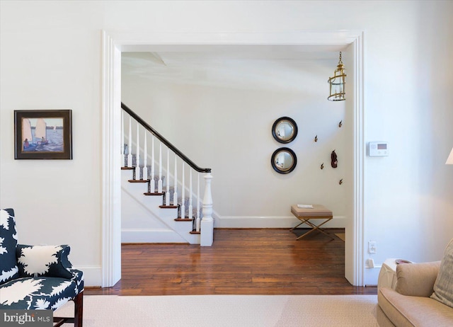 entryway featuring stairs, baseboards, and wood finished floors