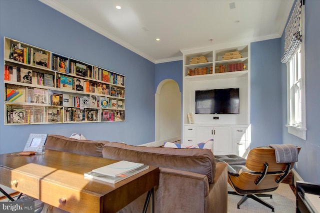 living room featuring arched walkways, recessed lighting, crown molding, and baseboards