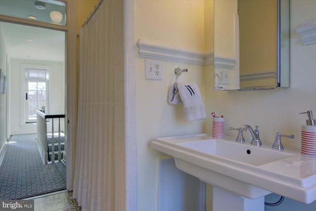 bathroom with a sink and a shower with curtain