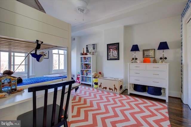 bedroom with baseboards and wood finished floors