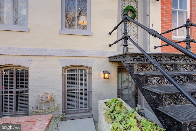 doorway to property with brick siding