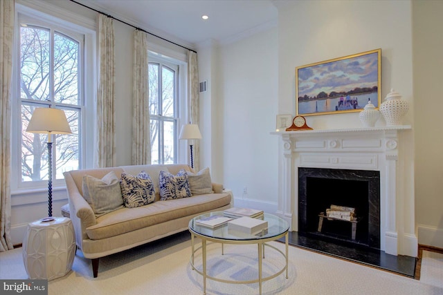 living room with baseboards, plenty of natural light, a fireplace, and crown molding