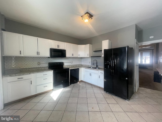 kitchen with white cabinetry, sink, tasteful backsplash, and black appliances