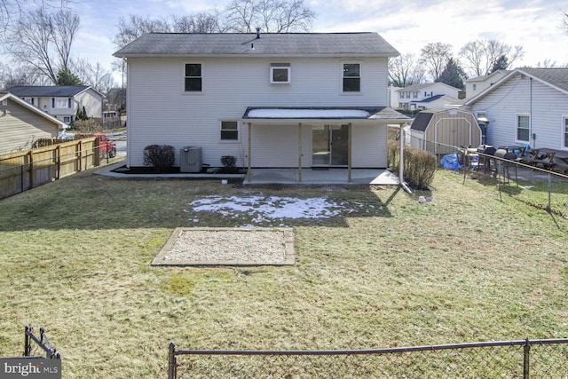 back of property featuring a patio, central AC unit, a shed, and a lawn