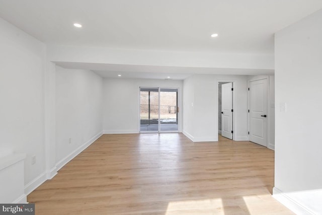 empty room with light hardwood / wood-style flooring