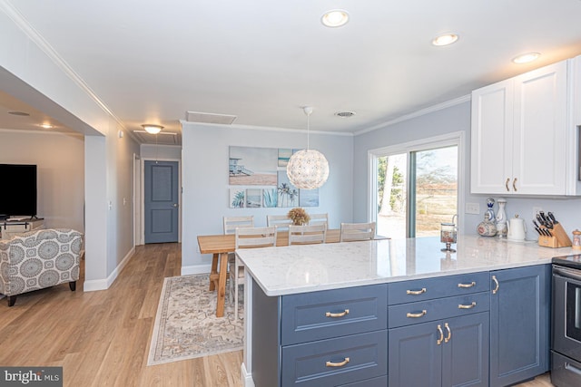 kitchen featuring pendant lighting, white cabinetry, ornamental molding, light hardwood / wood-style floors, and blue cabinetry