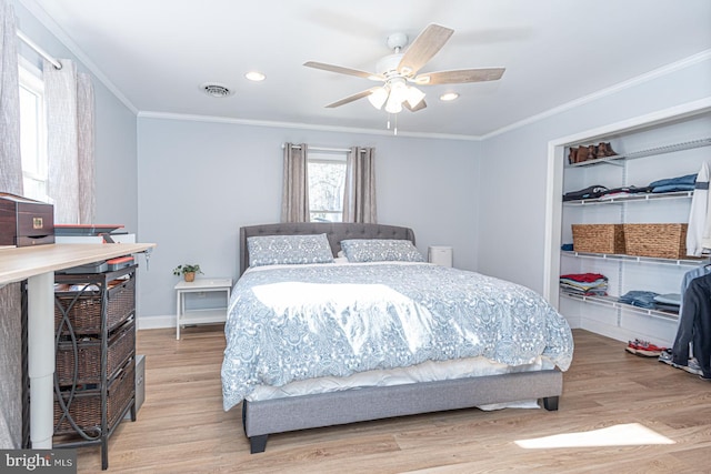 bedroom featuring crown molding, ceiling fan, and light wood-type flooring